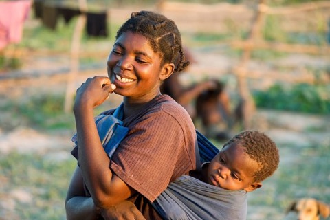 Tonga woman with child on her back
