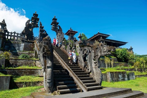 Balinese believers walk down stairs