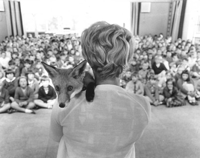 Woman with fox on her shoulder