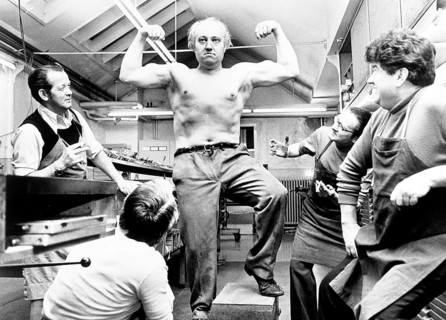 Strong man poses and shows his muscles