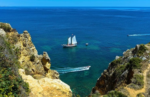 Sailboat and motorboats off Camilo Beach