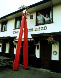 Man on stilts cleaning windows