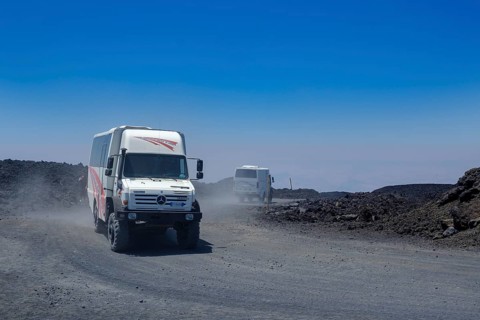 Four-wheel drive vehicles on gravel road to Etna volcano