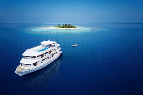 Diving safari ship MS Keana off an uninhabited palm island