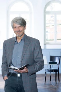 Man with calendar in front of his office window