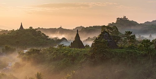 Mist over hills and stupas of Mrauk U at sunrise