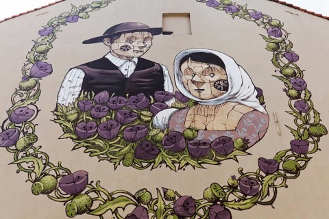 Medieval peasant couple in a wreath of flowers
