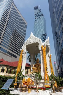 Decorated Hindu shrine with golden Brahma statue in front of luxury hotel W Bangkok
