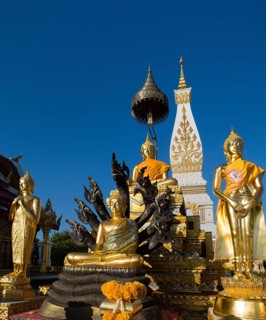 Golden Buddha statues in front of the Chedi of Wat Phra That Phanom