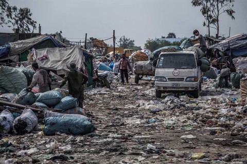 Garbage collectors on rubbish dump on the outskirts