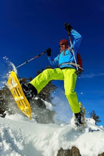 Snowshoe walker with big steps in the snow