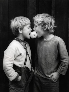 Two boys share an apple about 1970s