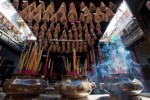 Smoke sacrifice with incense sticks and incense spirals