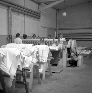 Women working on a warp weaving machine around 1950