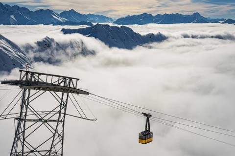 Mountain peaks protrude from clouds