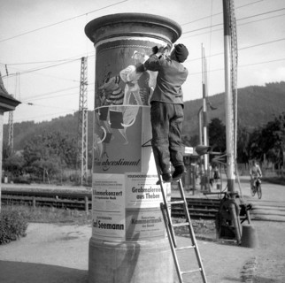 Advertising posters attached to advertising pillar ca. 1945