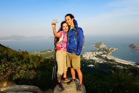 Hikers taking a selfie on a rock