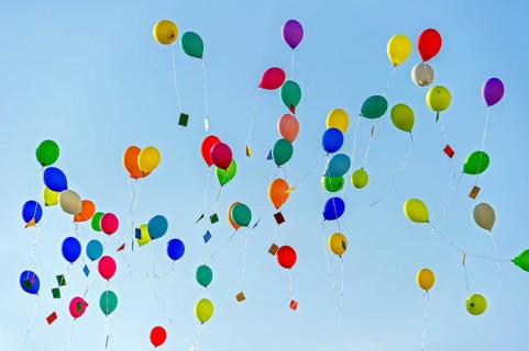 Colorful balloons rise to the sky