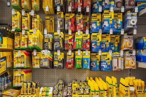 Various adhesives on shelves