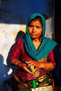 Woman wraps cigarettes into a bundle