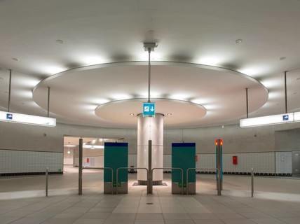Illuminated column in entrance hall with ticket machine