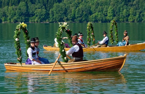 Men wearing traditional costumes in festively decorated squares