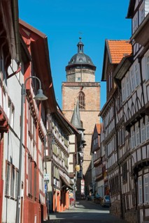 Narrow alley through half-timbered houses and Walpurgiskirche