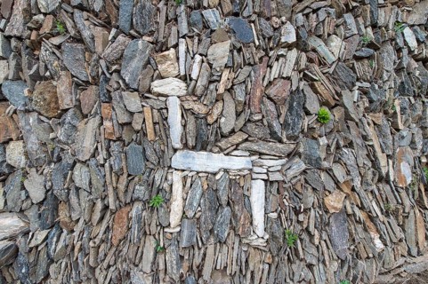 Llama figure in an old stone wall