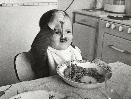 Toddler eats with spoon