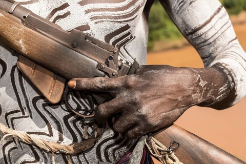 Hand of a warrior on rifle