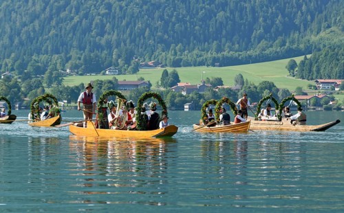 Men wearing traditional costumes in festively decorated squares