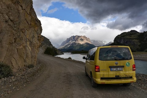 Yellow travel minibus on road to Lago del Desierto at Rio de las Vueltas