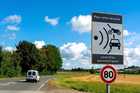 Sign of speed limit reduced to 80 km/hour and radar speed check