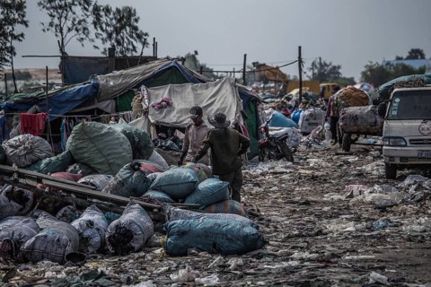 Garbage collectors on rubbish dump on the outskirts