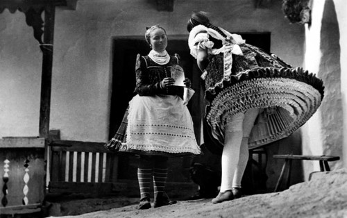 Two women in traditional costumes with many petticoats