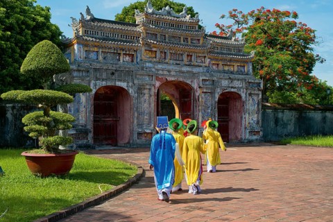 Vietnamese extras walk through West Gate