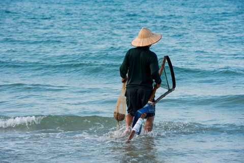 Fisherman wearing a straw hat