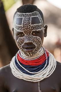 Young woman with traditionally painted face