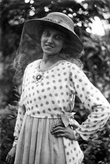 Woman with hat and mosquito net on her face