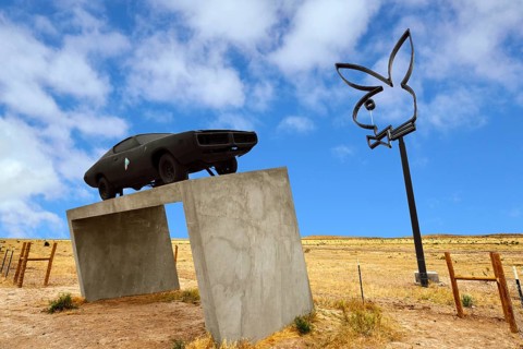 Playboy Bunny and sports car on a concrete base
