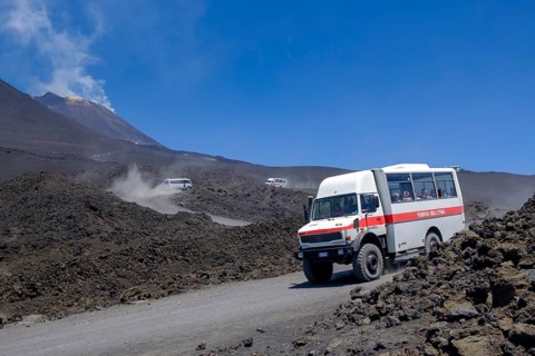 Four-wheel drive vehicles on gravel road to Etna volcano