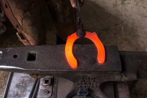 Glowing horseshoe on an anvil