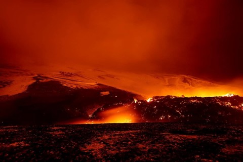 Glowing lava and lava flow at night on Fimmvorouhals volcano