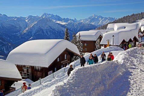 Village road with snow-covered chalets in the village towards Dom 4545m