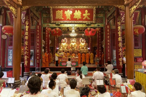 Prayer hall with Buddhist monks and believers