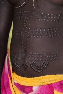 Young woman with ornamental scars on the belly