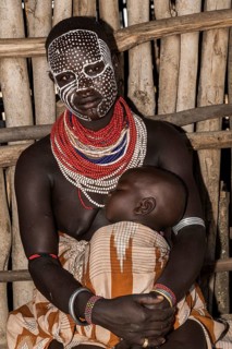 Young woman with painted face and baby