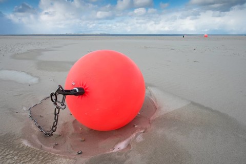 Buoy on the beach in the sand