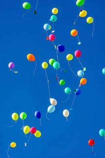 Colorful balloons rise to the sky