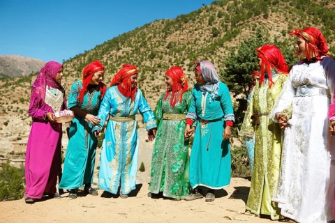Dancing women in colorful dresses